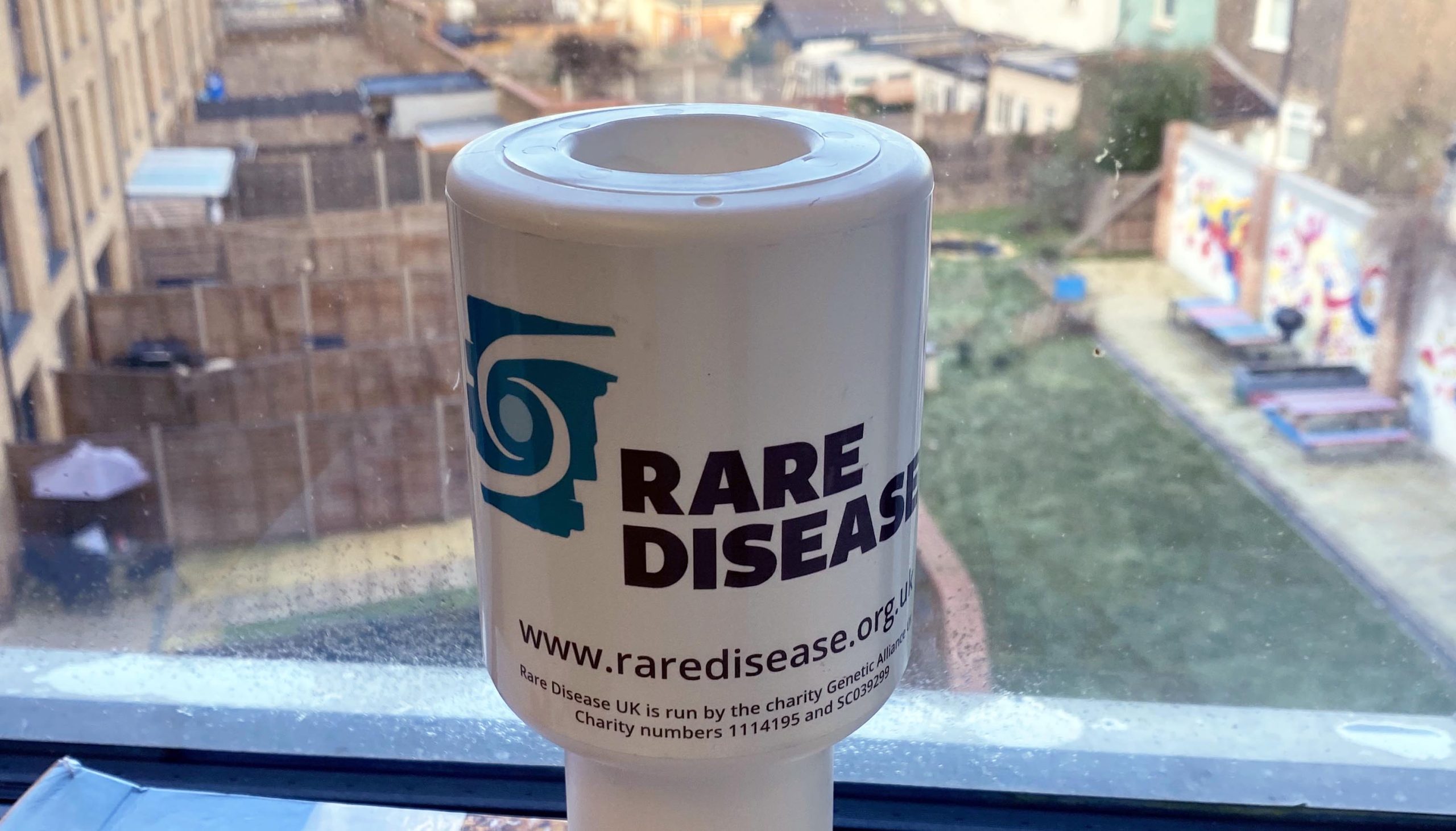 Rare Disease UK branded fundraising tub