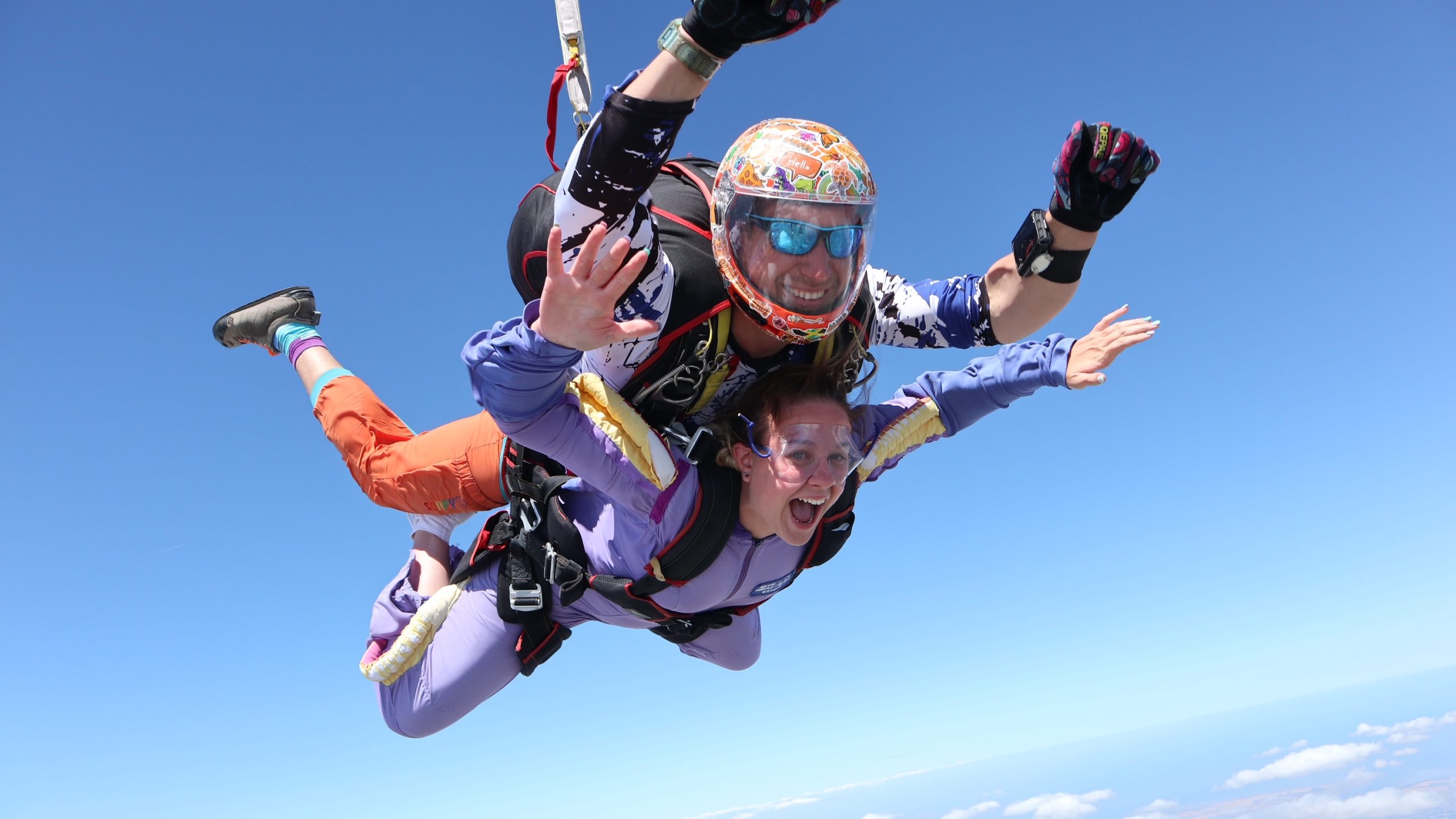 Lucia skydiving for Rare Disease UK. She is jumpinb on a bright, blue skied, sunny day