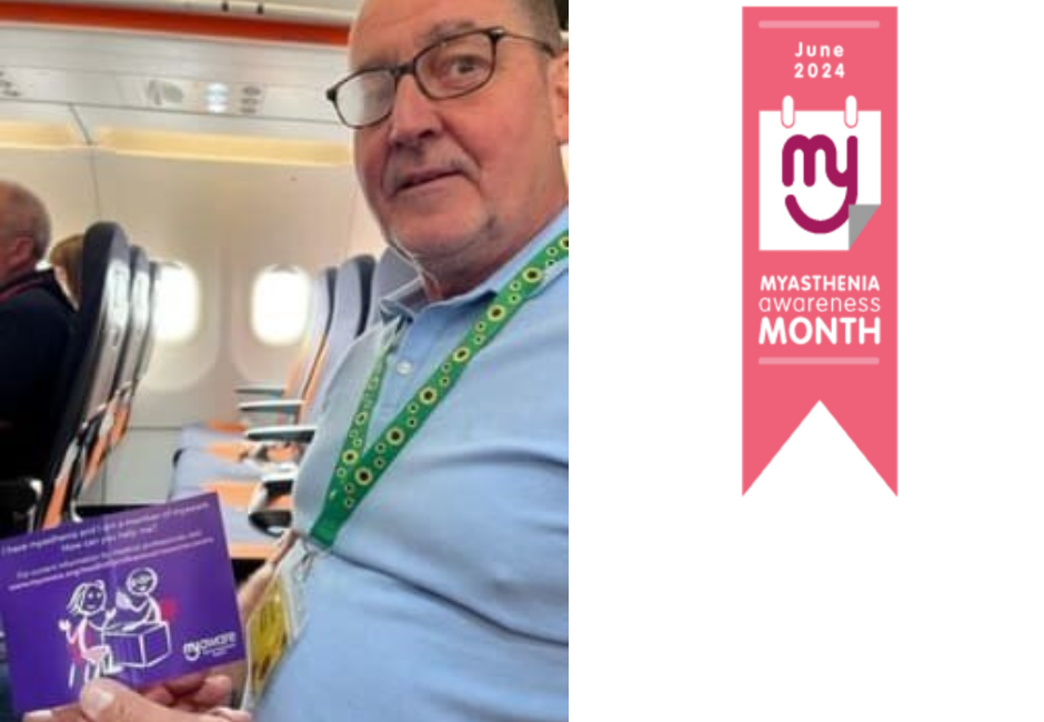 A man sat on a plane holding up a purple leaflet. He wears a sunflower lanyard around his neck. He wears glasses and looks at the camera